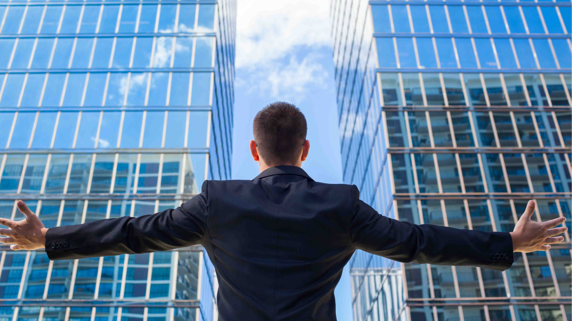 Business man facing two modern buildings